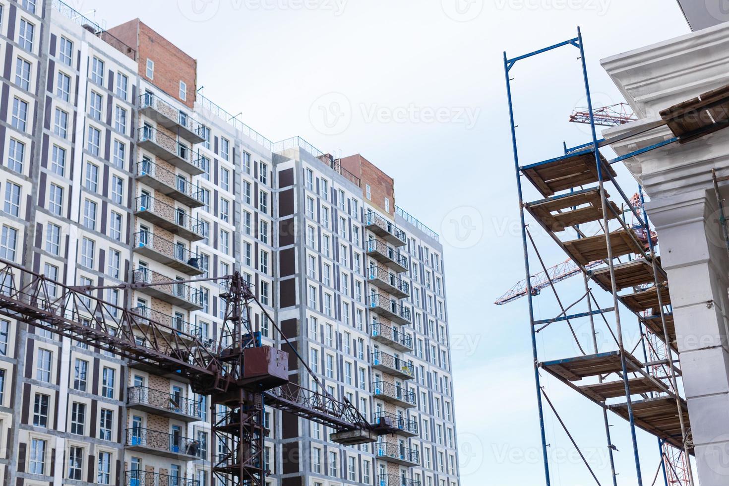 Extensive scaffolding providing platforms for work in progress on a new apartment block UK photo