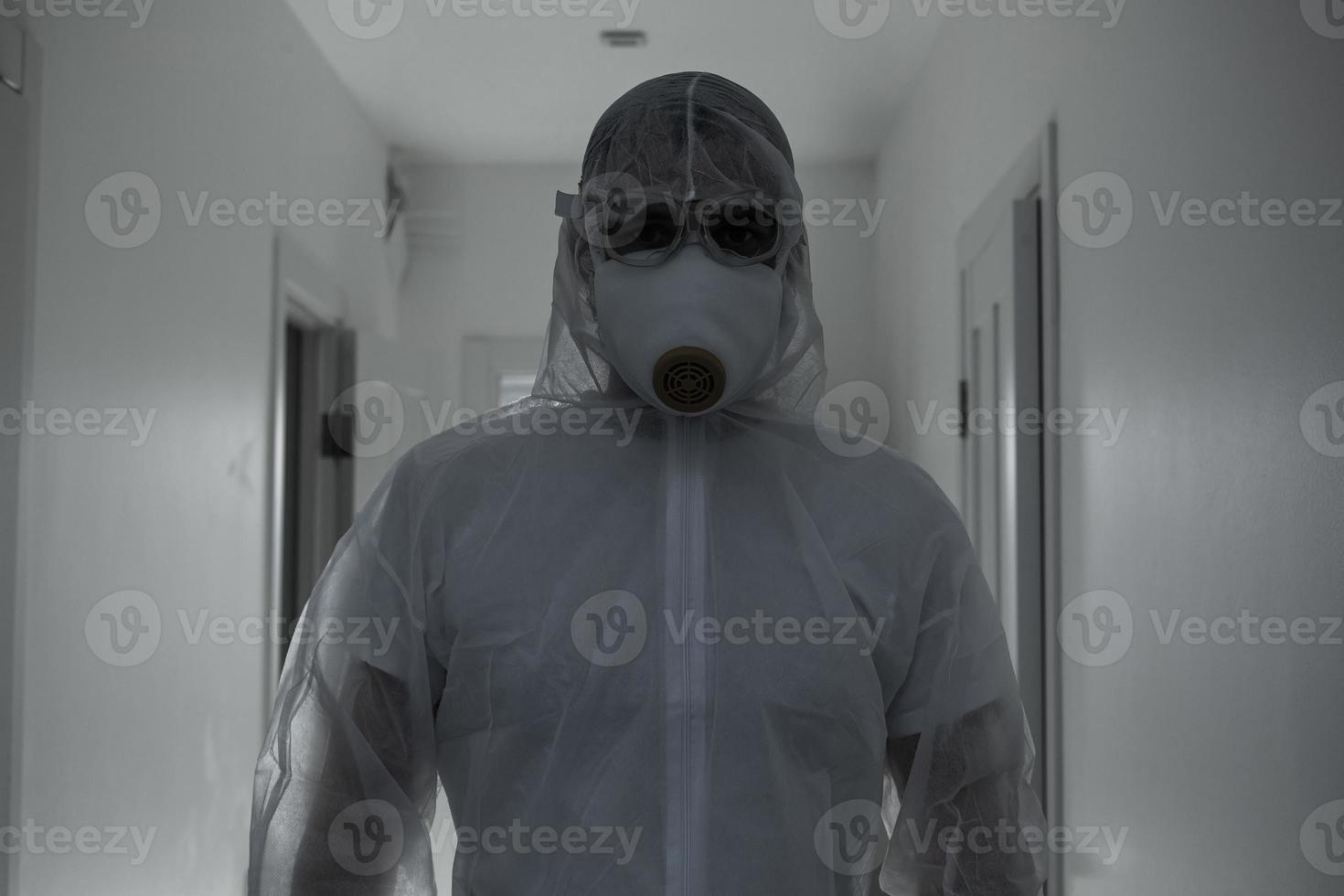 Scientist in protective wear, glasses and respirator photo