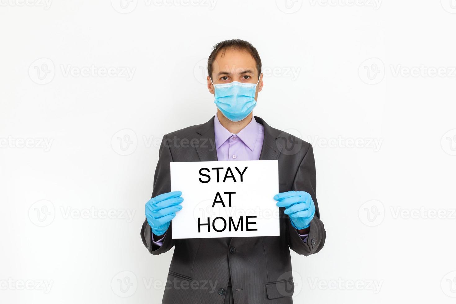 Portrait of Businessman with Mask Holding Stay At Home Banner, Concept for Coronavirus and Business photo