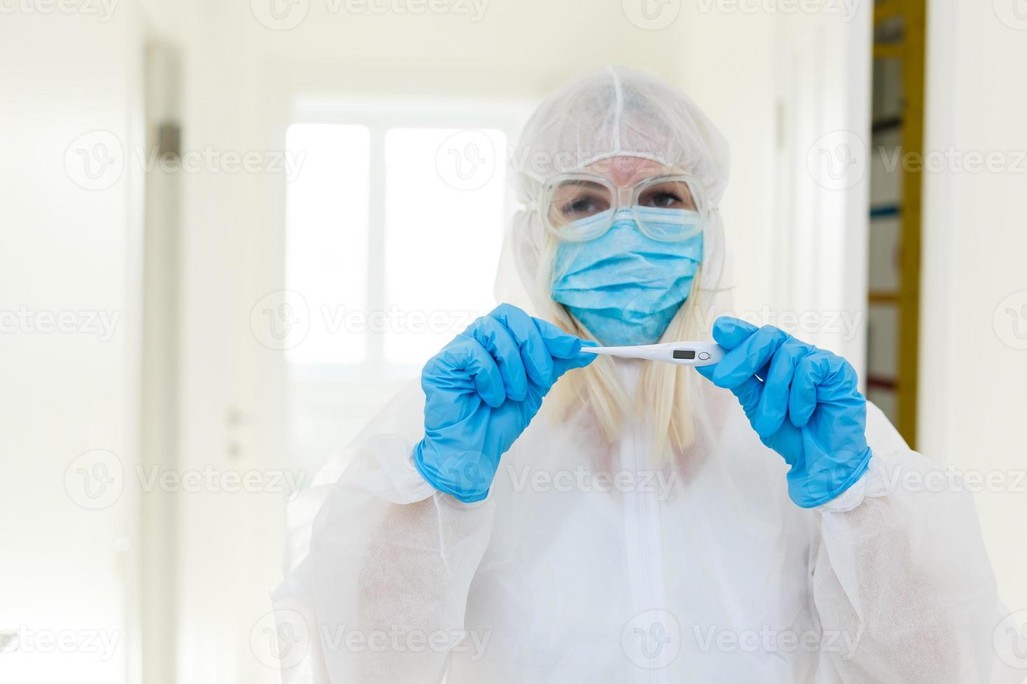 Chinese woman weared in protective suit. Gas mask as a protection against many infections and allergens. Health care worker. photo