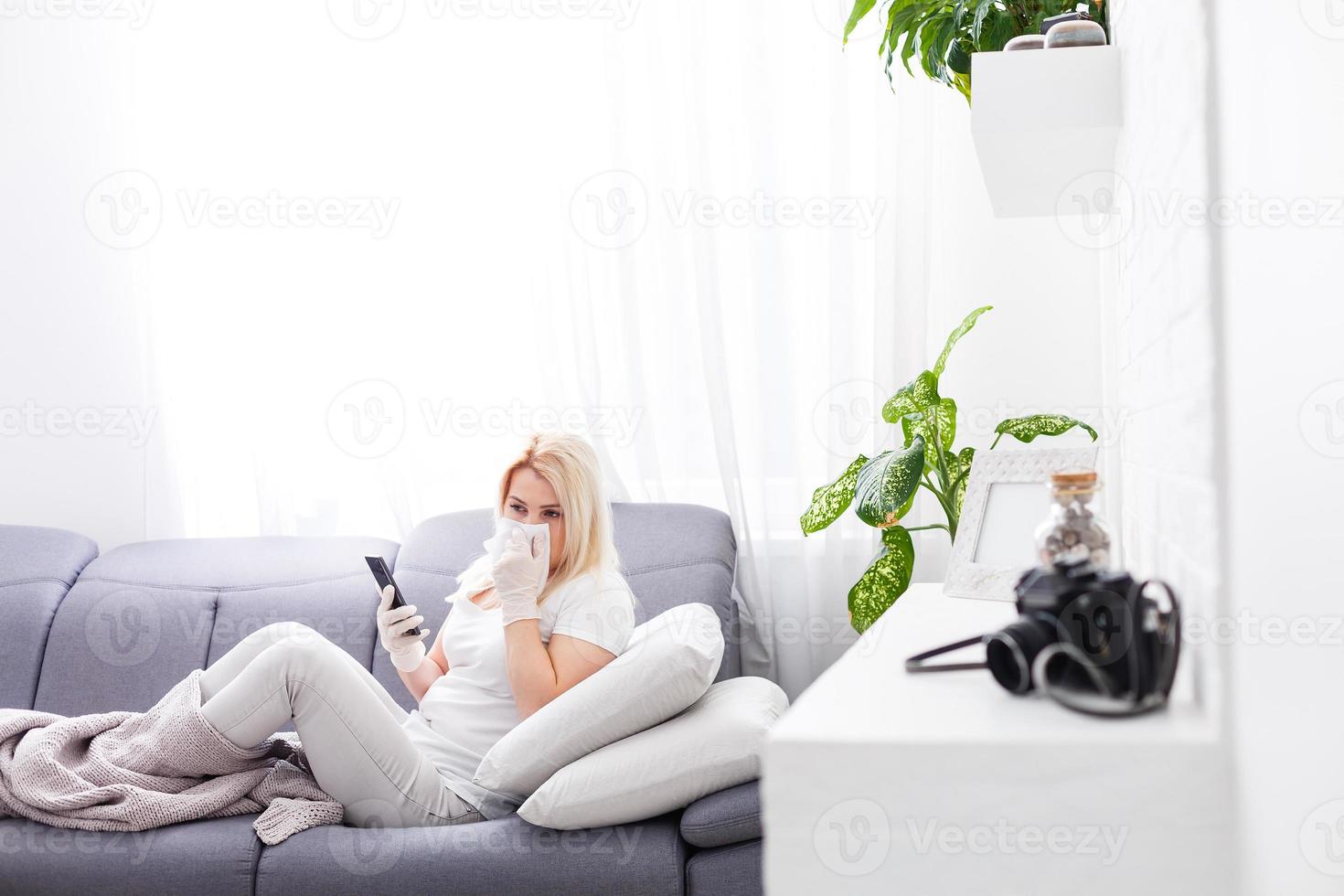 Portrait of a sick woman alone . An infectious agent protection gear including a mask. An sick older woman wearing protective masks to protect against virus. Coronavirus. Quarantine at home. photo