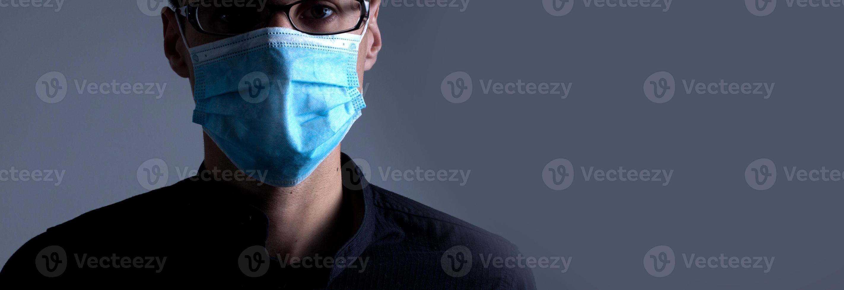 Strong man wearing mask to prevent flu virus and dust air pollution on white background photo