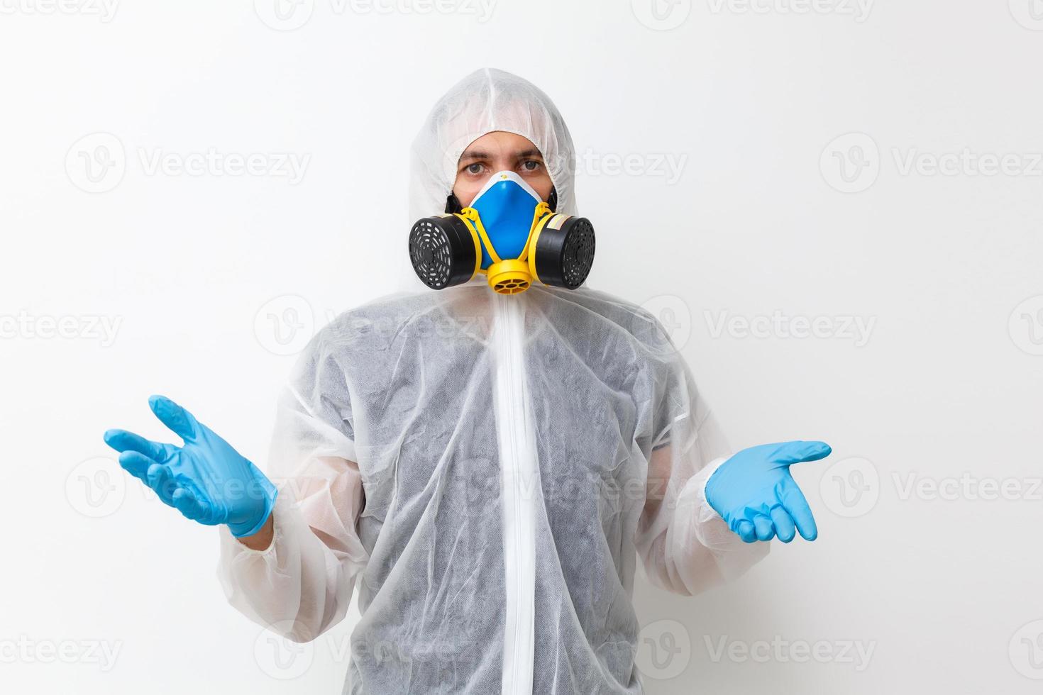 Man in protective clothing and a gasmask on a white background photo