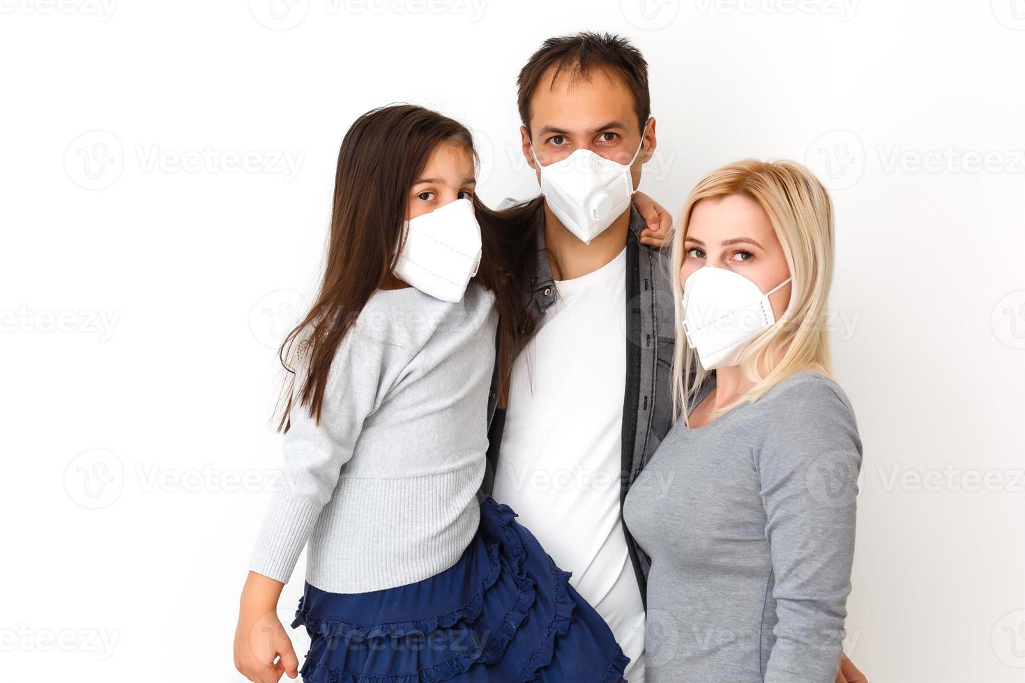 family in protective masks quarantined. Normal life with coronavirus. Lifestyle COVID-19. Quarantine virus protection sterility home together heart symbol photo