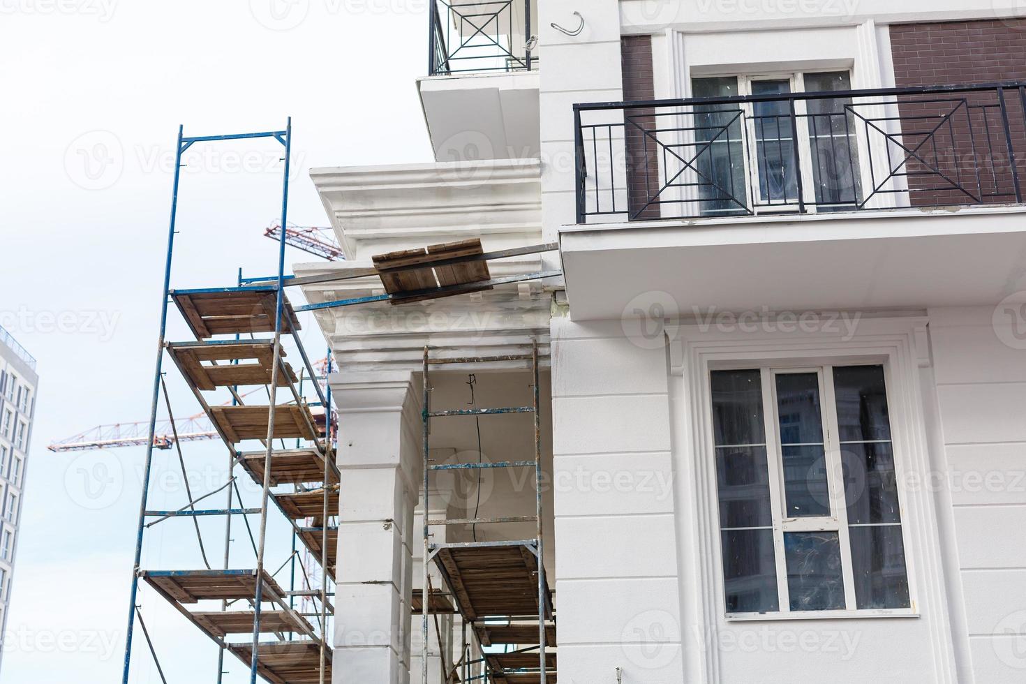 Extensive scaffolding providing platforms for work in progress on a new apartment block UK photo