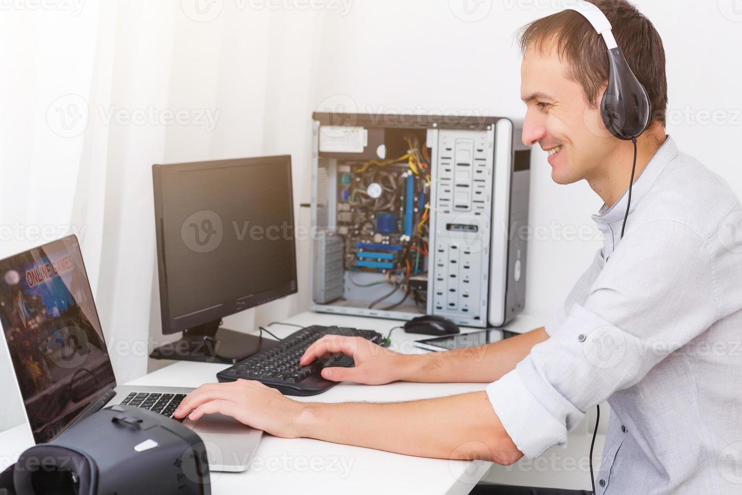 Young happy man laughing and playing video games on weekend photo