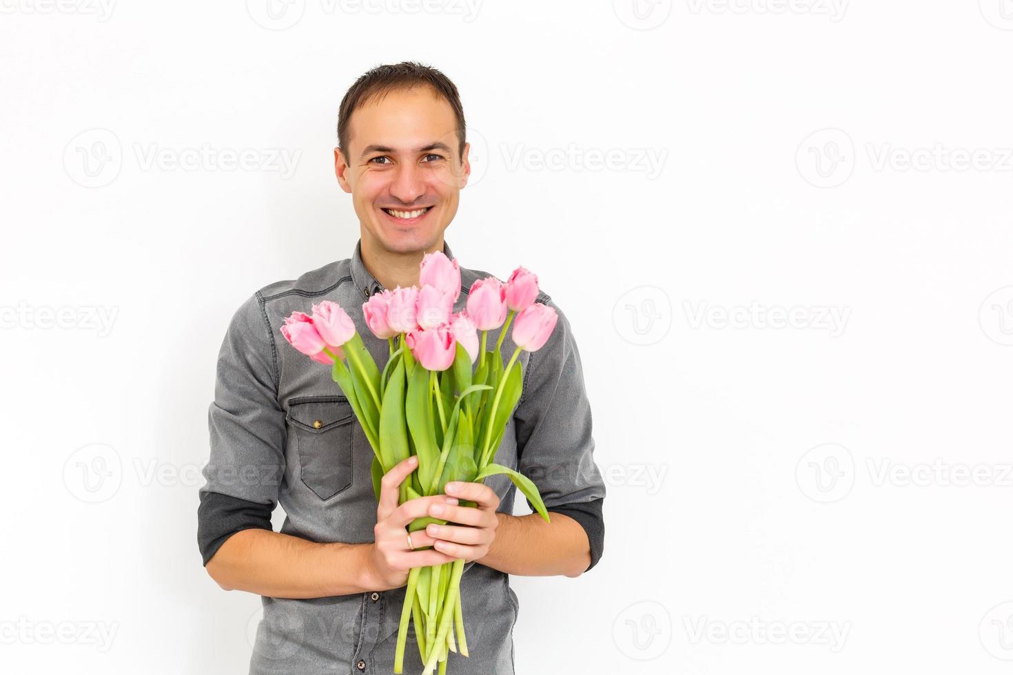 Man with flowers. Romantic Man with bouquet of tulips for birthday. Happy woman's day. Giving bouquet of flowers. Handsome man giving flowers. White background. Horizontal photo.s photo