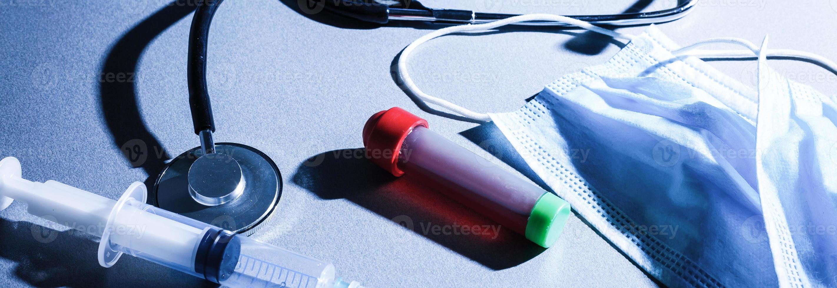 coronavirus covid 19 infected blood sample in sample tube in hand of scientist with biohazard protection clothing in coronavirus covid 19 reseach laboratory, coronavirus covid-19 vaccine research photo