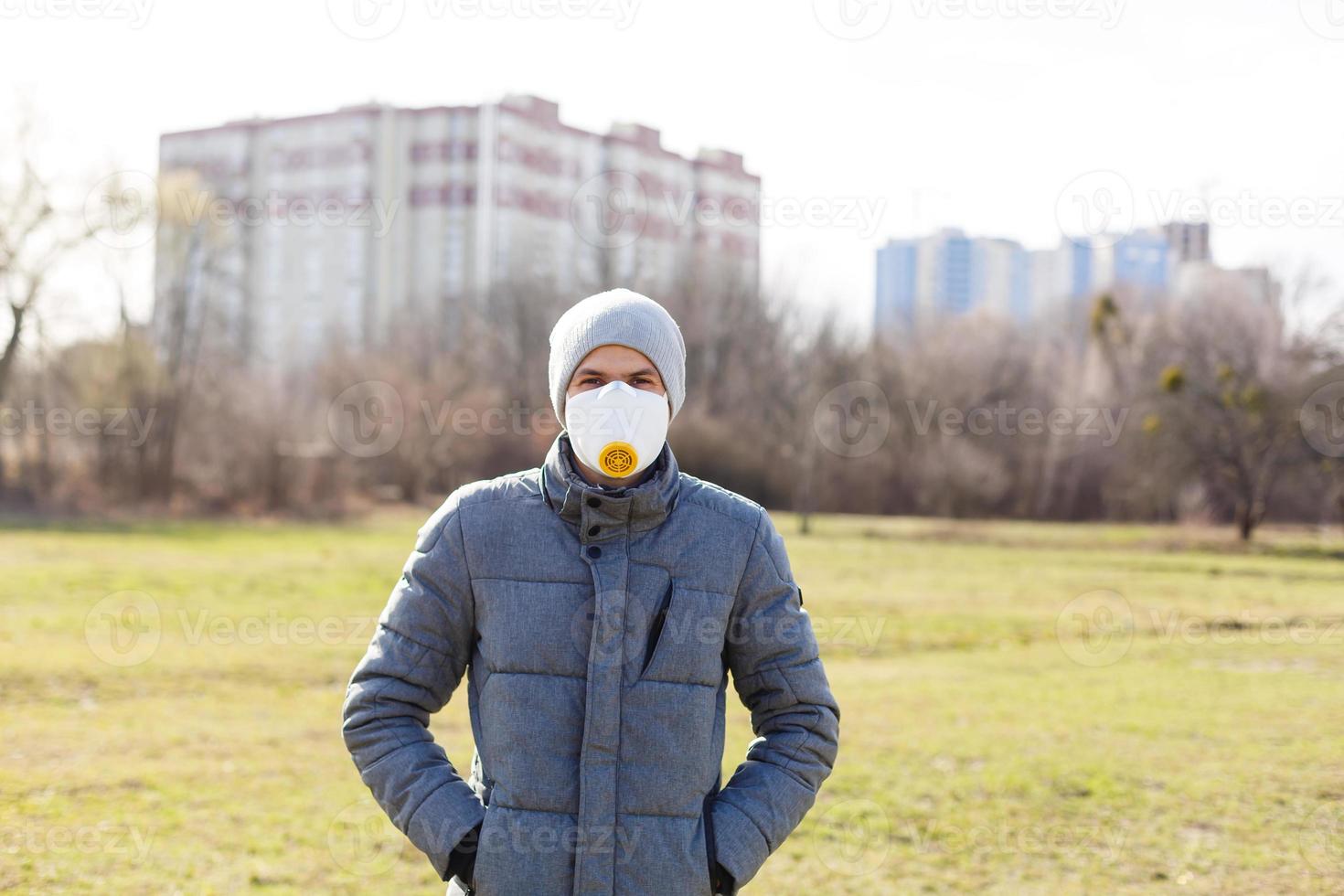 Young man wearing a face mask to protect against flu or infections photo