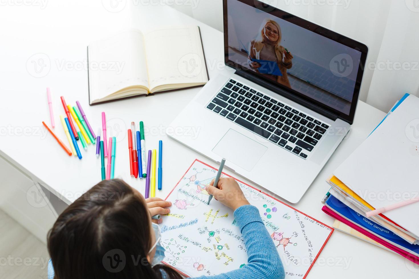 Woman video conferencing with tutor on laptop at home. Distance education concept. photo