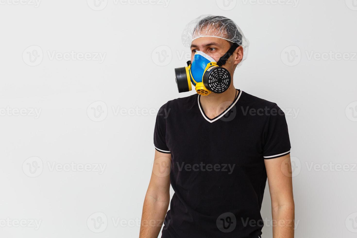 Man in protective clothing and a gasmask on a white background photo
