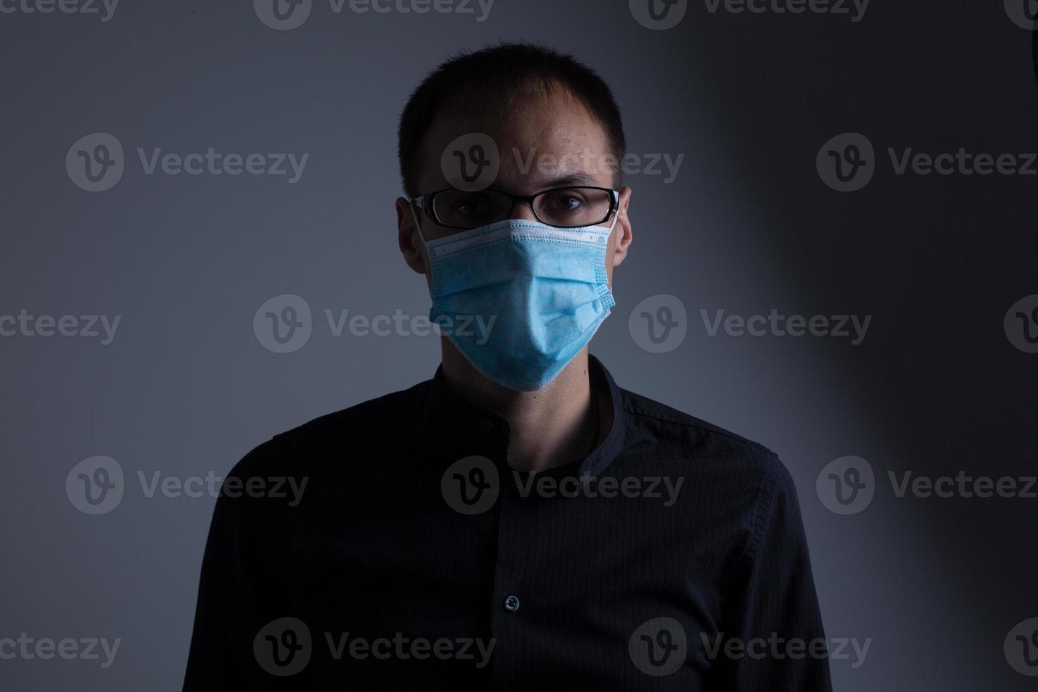 Strong man wearing mask to prevent flu virus and dust air pollution on white background photo