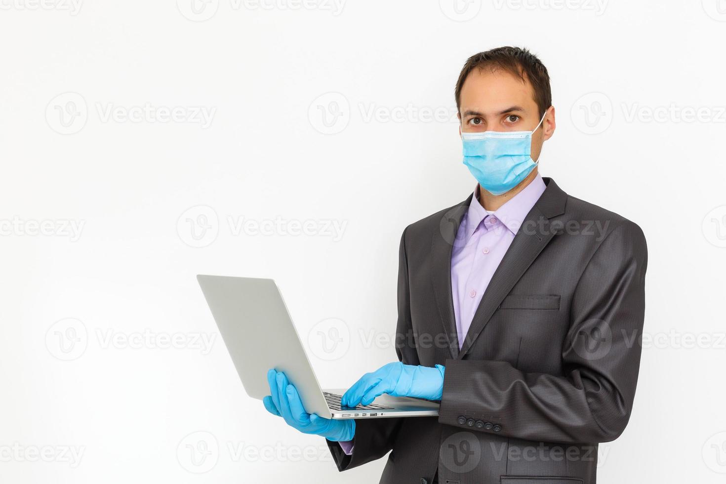 Close up of a businessman in a suit wearing Protective face mask, get ready for Coronavirus and pm 2.5 fighting against gray background. Healthcare concept. photo