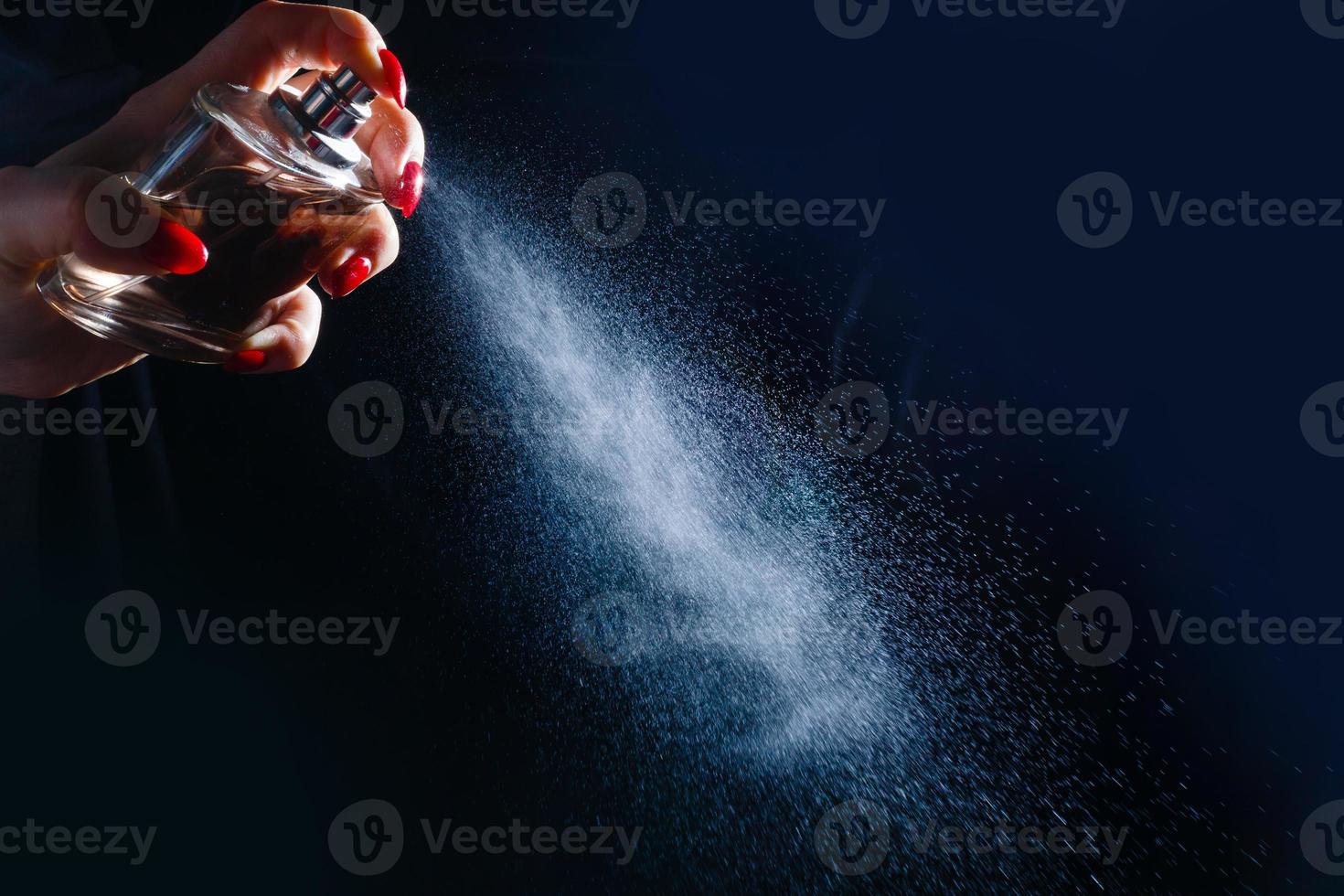 Hand of lady that applying alcohol spray or anti bacteria spray to prevent spread of germs, bacteria and virus. Personal hygiene concept. photo