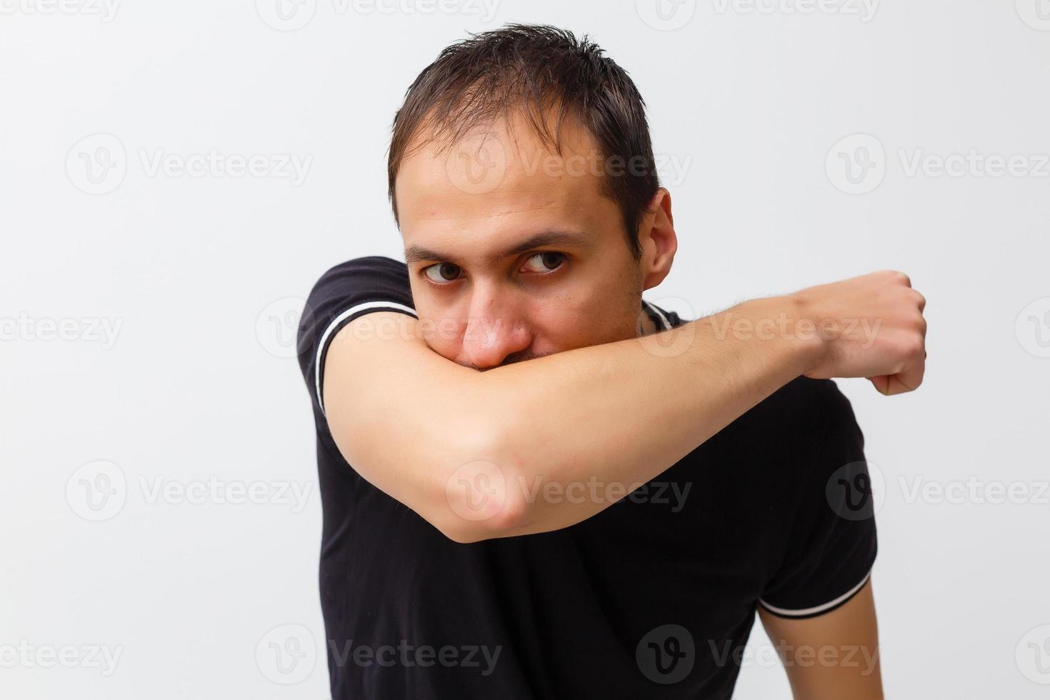 Close-up of a young man having a cough photo