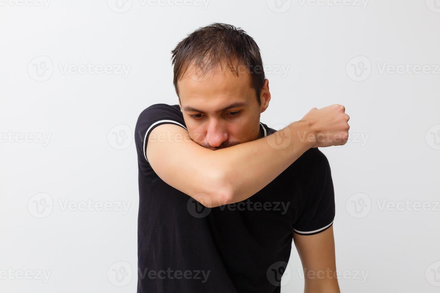 Close-up of a young man having a cough photo