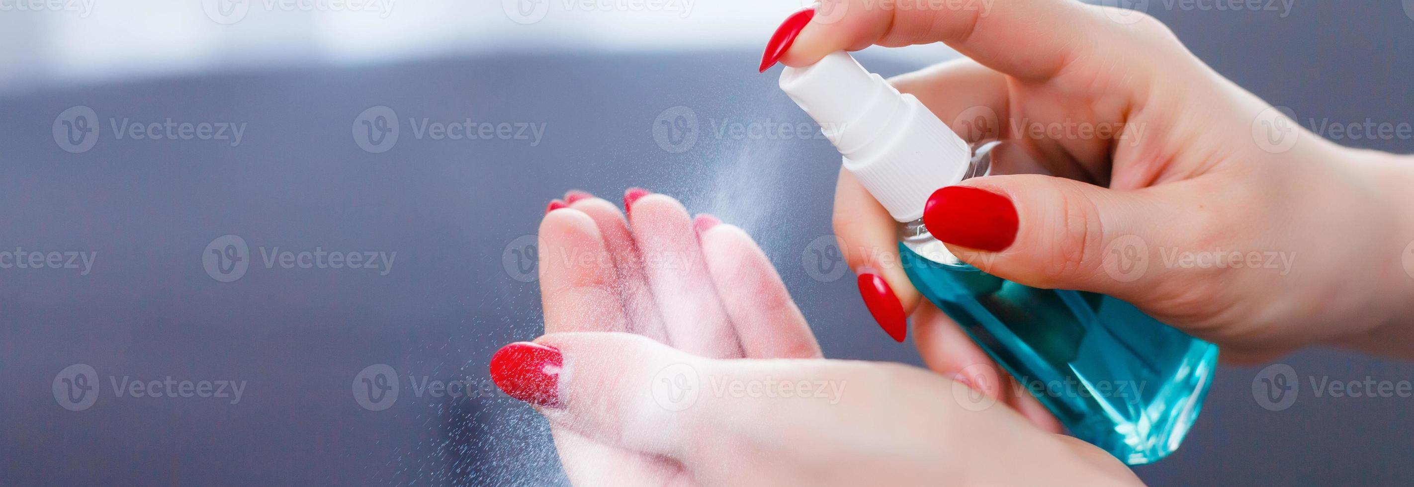 Hand of lady that applying alcohol spray or anti bacteria spray to prevent spread of germs, bacteria and virus. Personal hygiene concept. photo