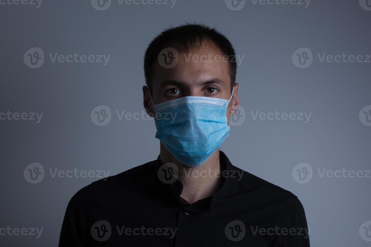 Strong man wearing mask to prevent flu virus and dust air pollution on white background photo