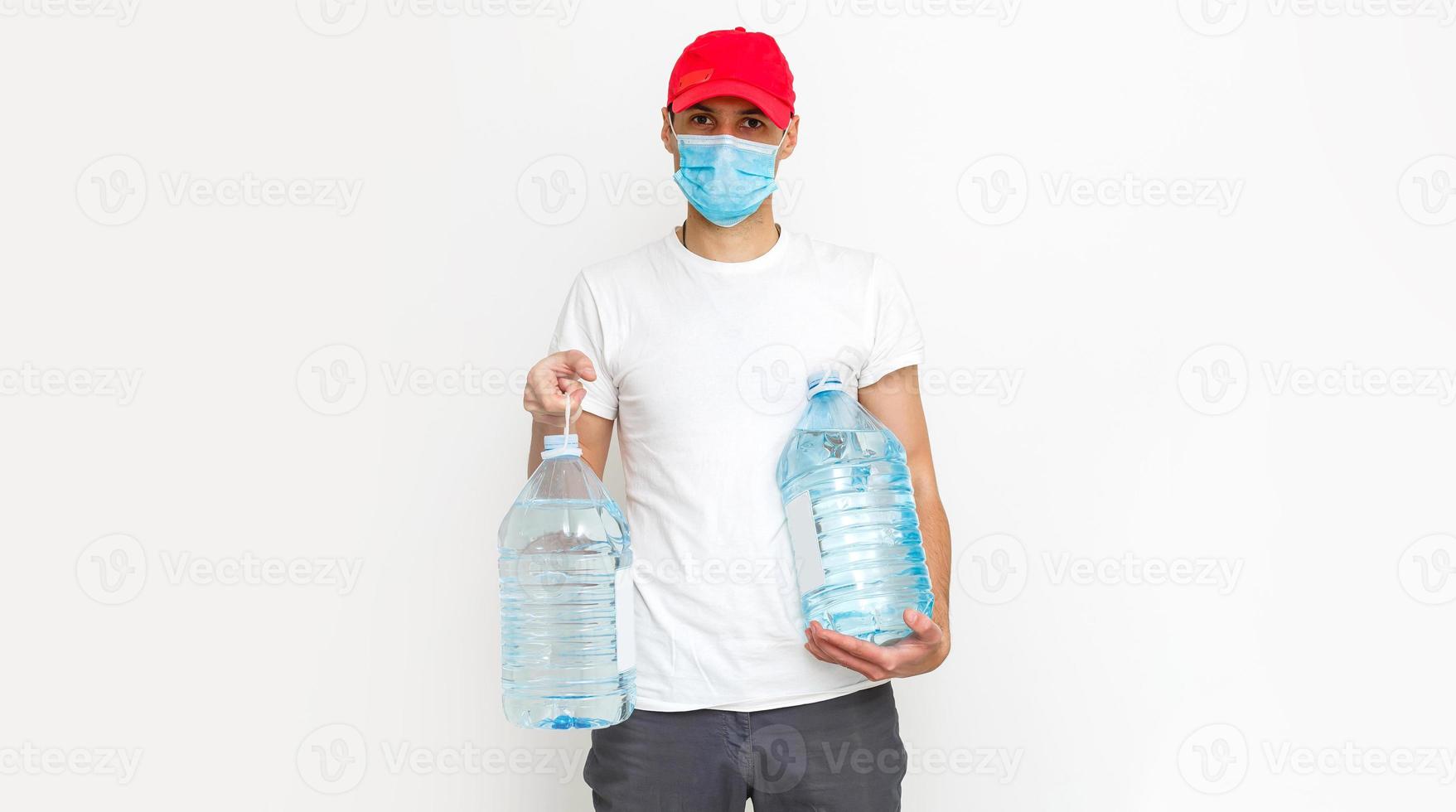 Strong water delivery man in protective mask. Isolated on white. photo