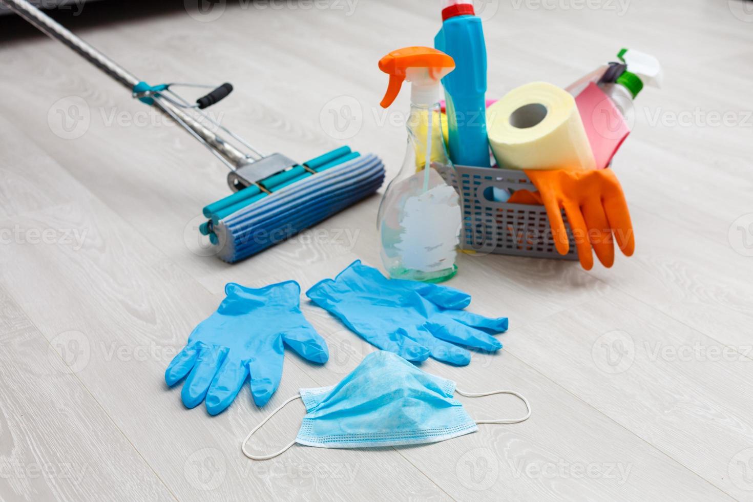 cleaning, health and hygiene concept - rprotection from virus disease in gloves with detergent and mop at home photo