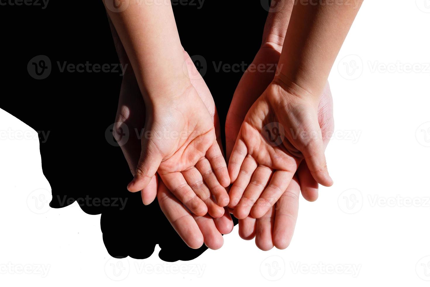 A closeup family photograph of a dad or father holding his infant boy or son's tiny open baby hand and fingers in his palm. photo