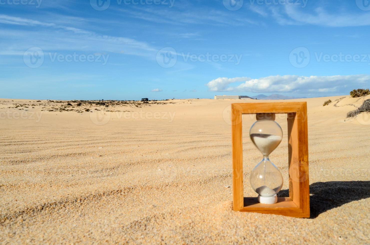 Hourglass in the sand photo