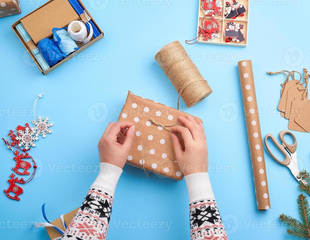 gift wrapped in pink paper and tied with a brown rope photo