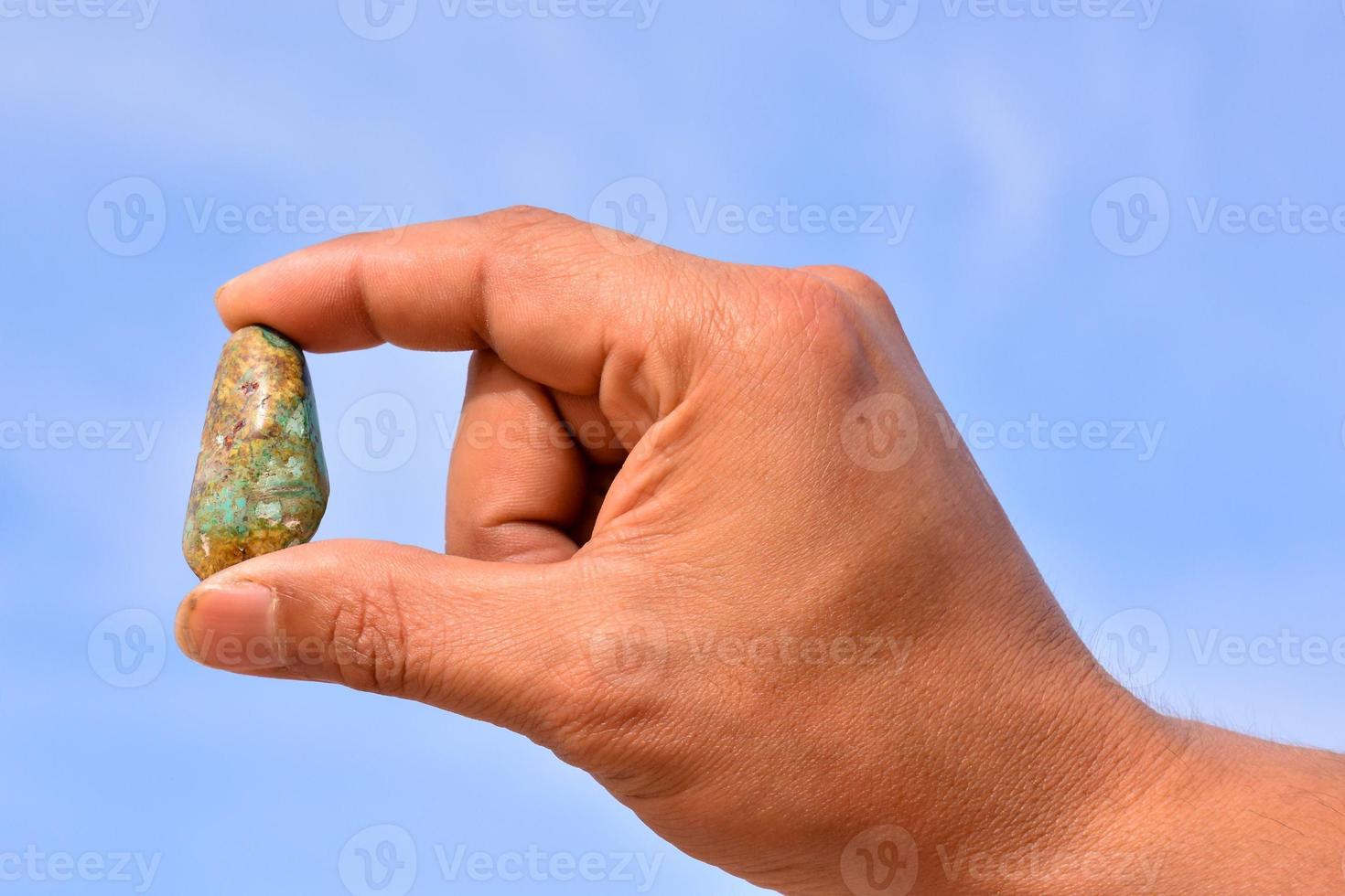 Holding small gemstone photo