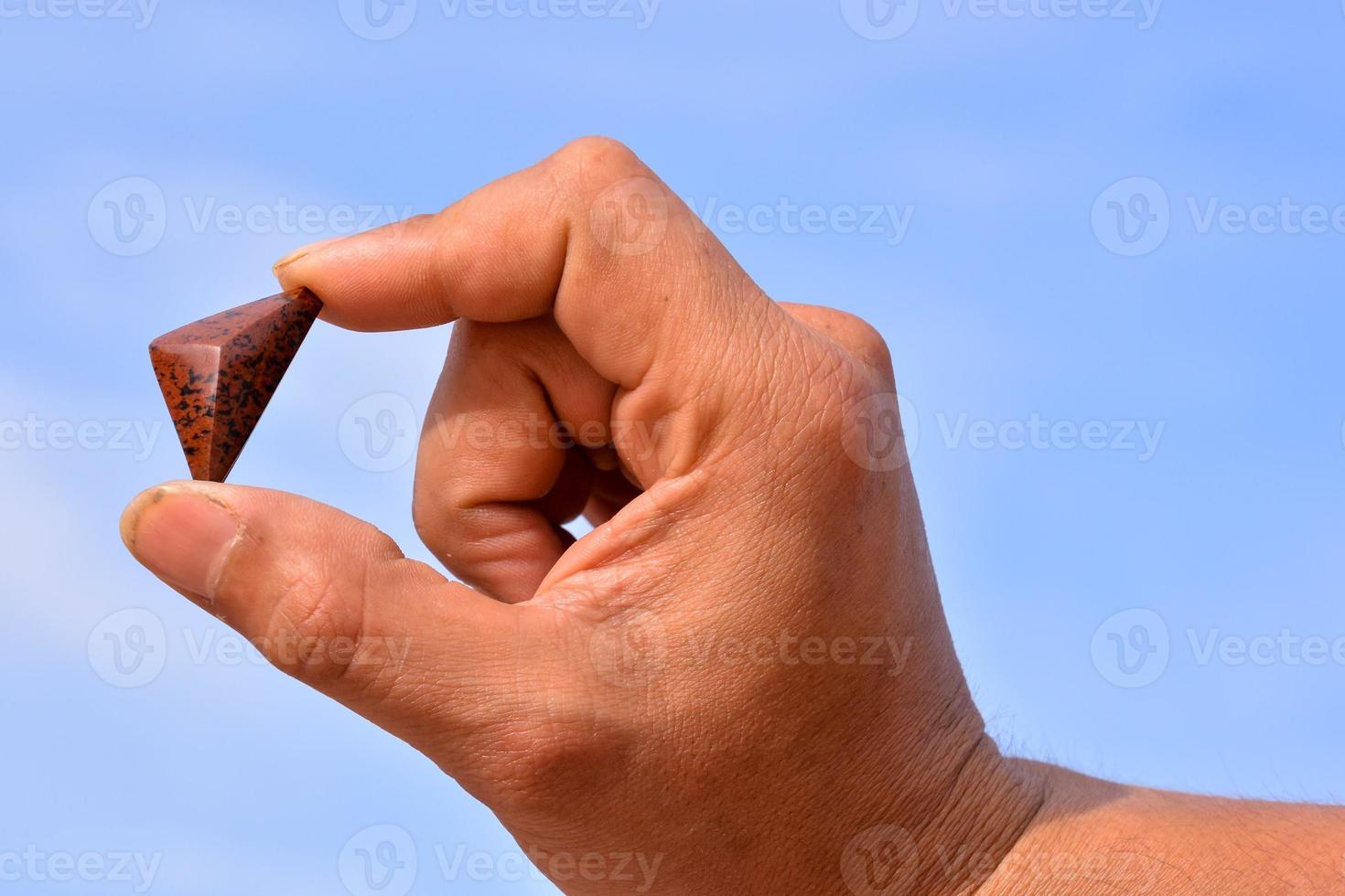 Holding small gemstone photo