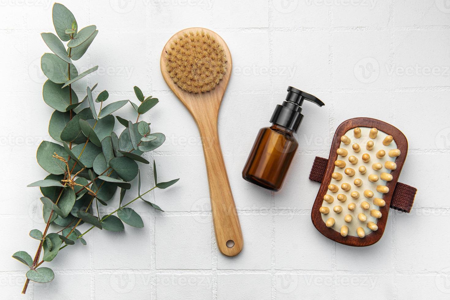 Spa treatment concept. natural spa cosmetics products with eucalyptus oil,, massage brush, eucalyptus leaf. photo