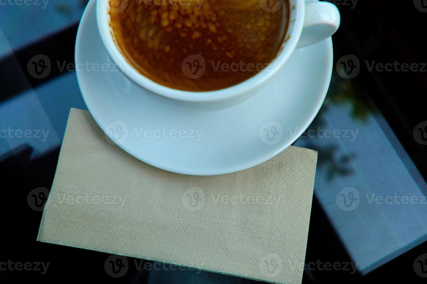 Top View of Brown Tissue Paper under White Cup of Coffee with Space for Texture. photo