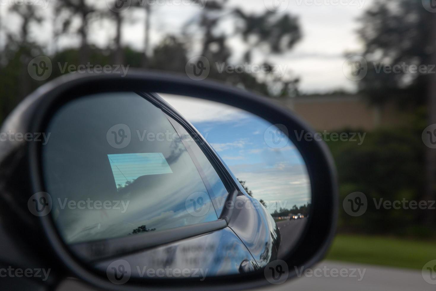 Speeding Car through a rear view mirror photo