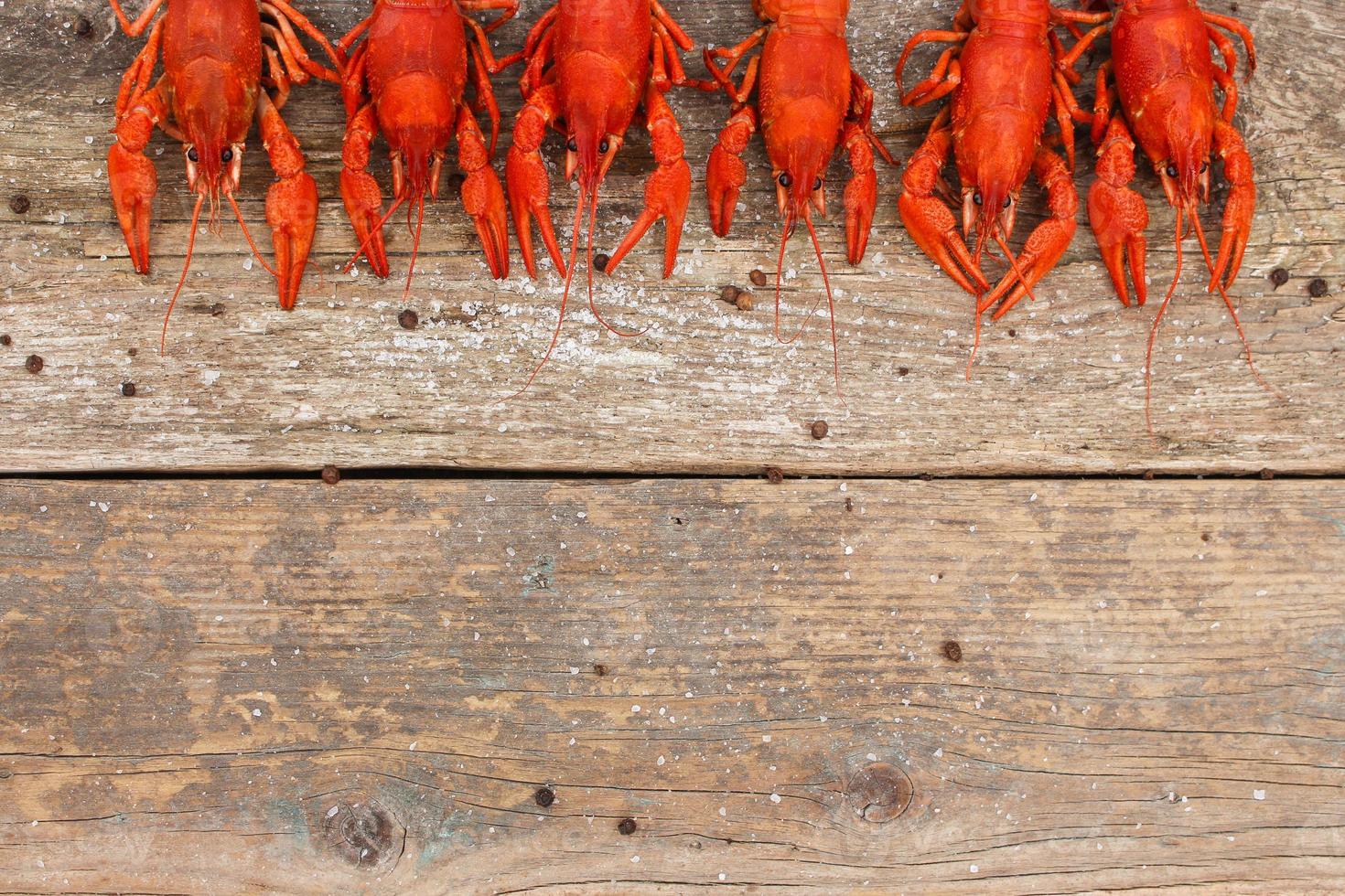 Crawfish on the old wooden background. Top view. photo