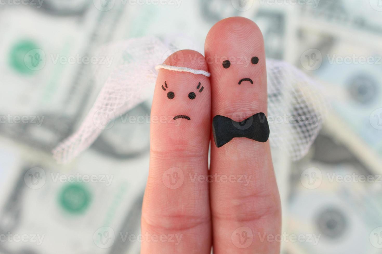 Fingers art of couple on background of money. Concept of wedding, woman and man needs to get married, but they don't want. Arranged marriage. photo