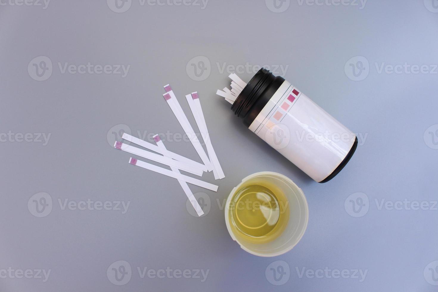 Urine test strips on a gray background. photo