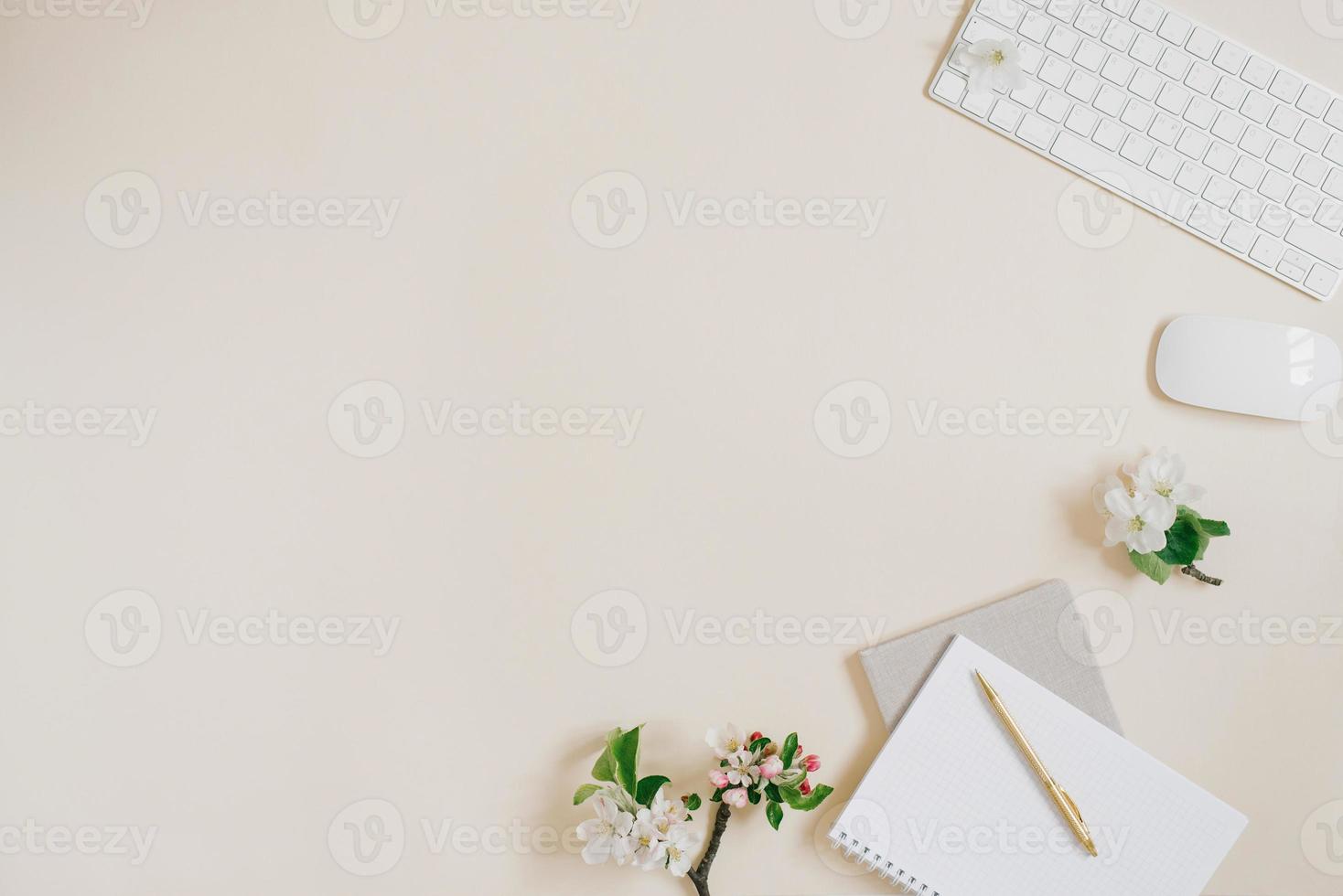 A flat scene in beige tones for a self-employed freelance girl. Planner, pen, computer and white apple flowers. Sketchy notebook or notebook mockup. photo