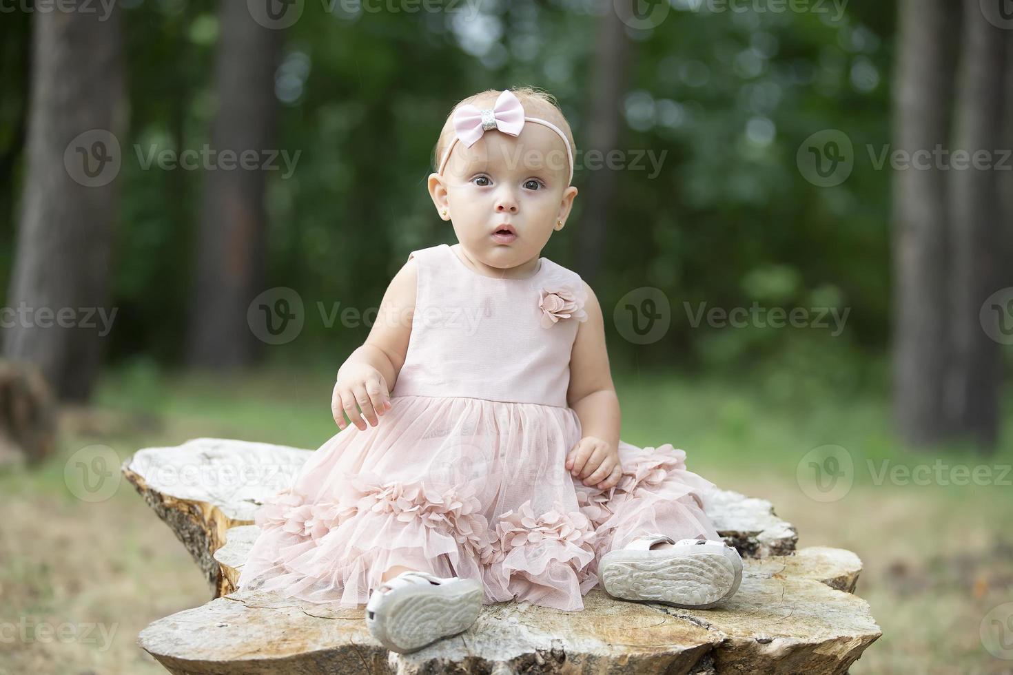 Portrait of a beautiful one-year-old girl on a summer walk. photo