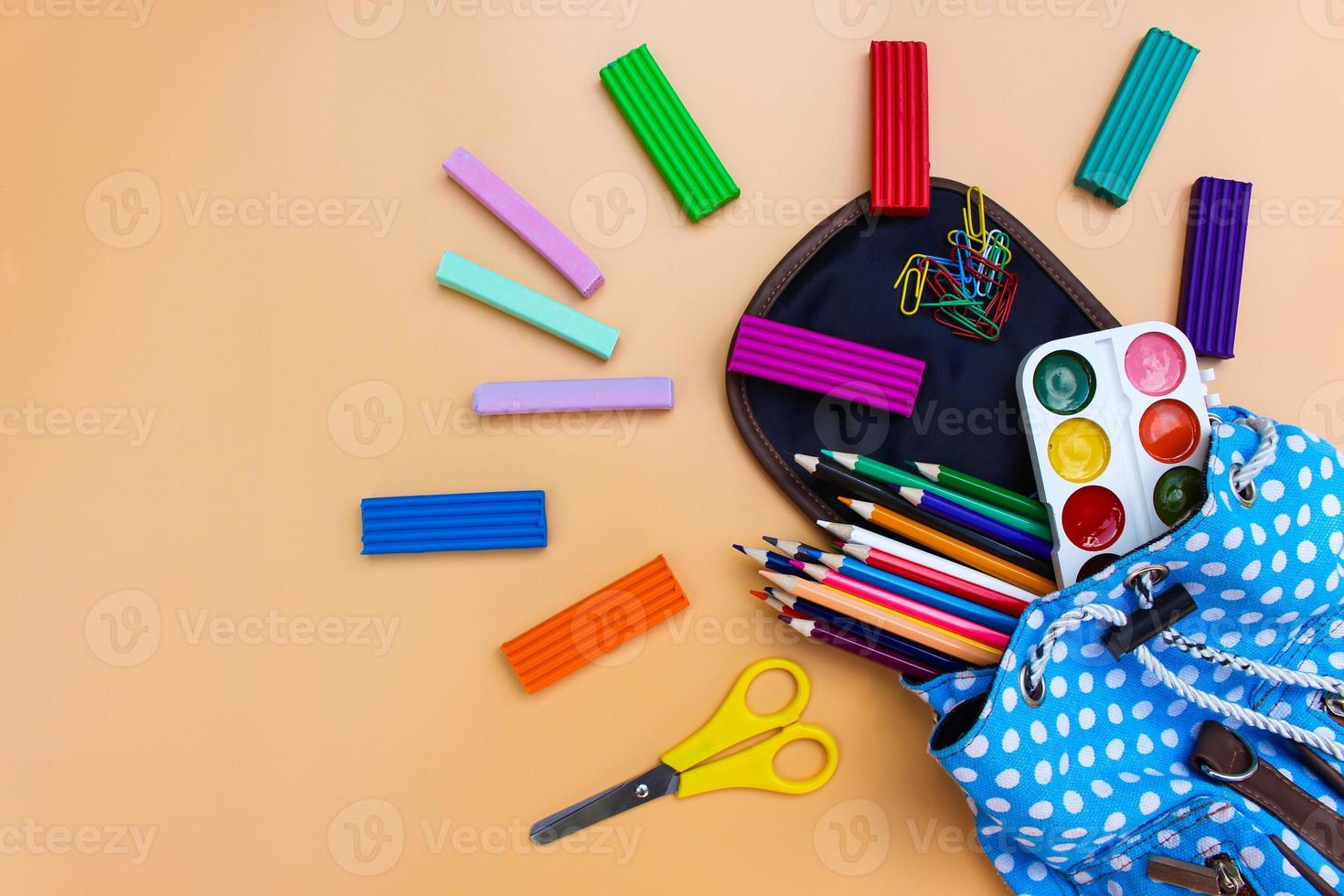 School supplies fall out of backpack. Top view. photo