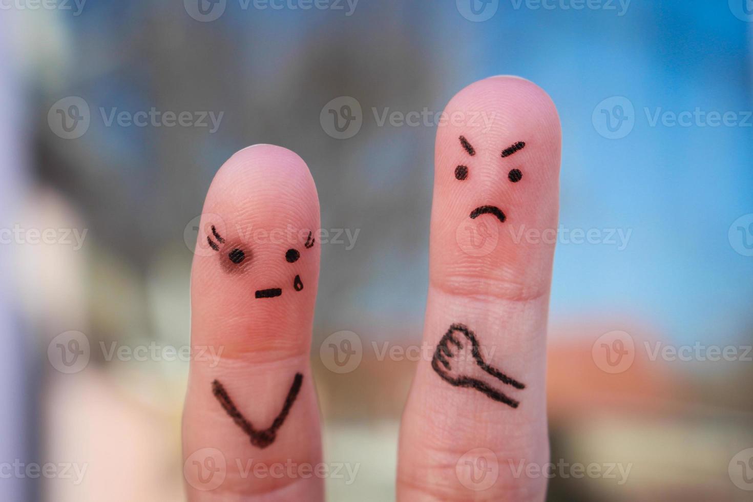 Finger art of family during quarrel. Concept of husband beat his wife. Woman has a black eye. photo