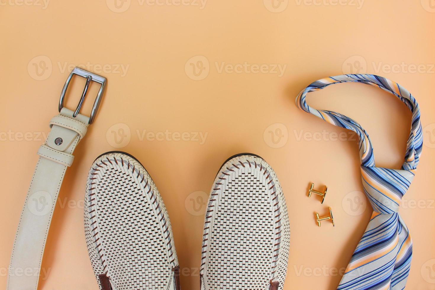 Men's accessories on beige background. Top view. photo