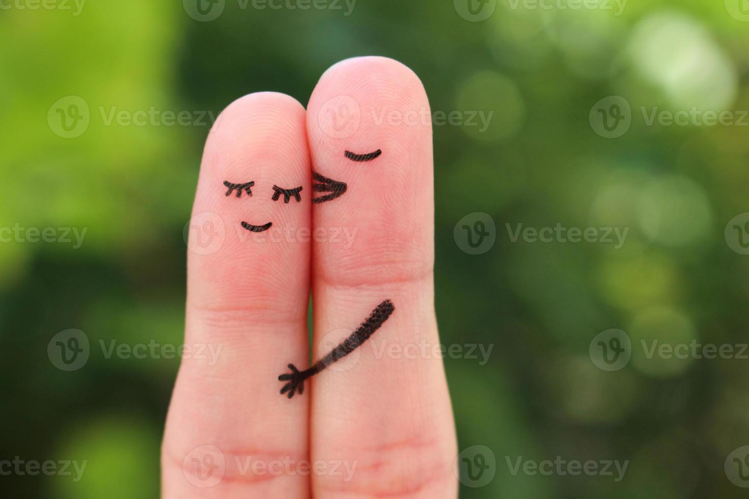 Fingers art of happy couple. Man kisses woman on cheek. photo