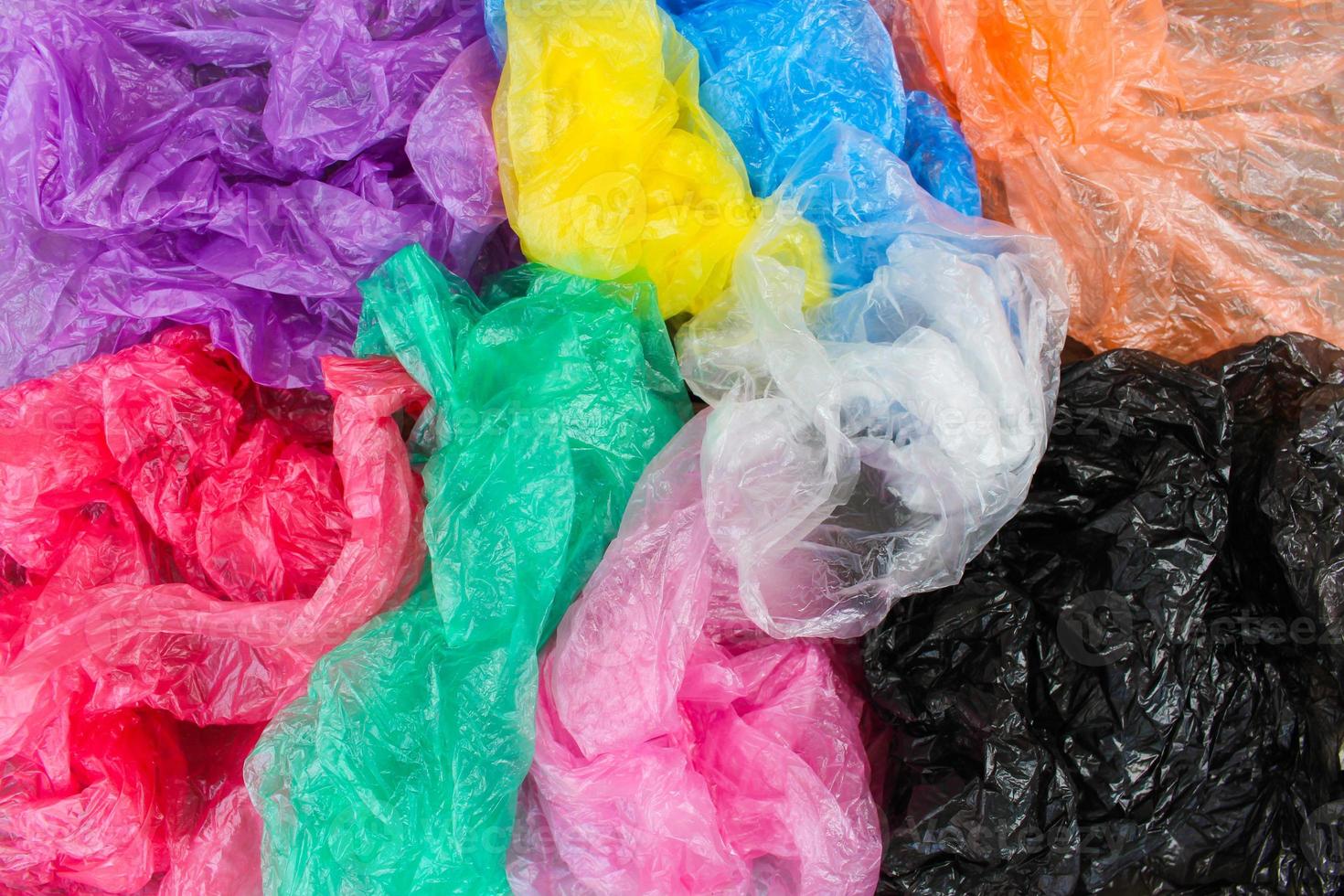 Different plastic bags on old wooden background. Top view. photo