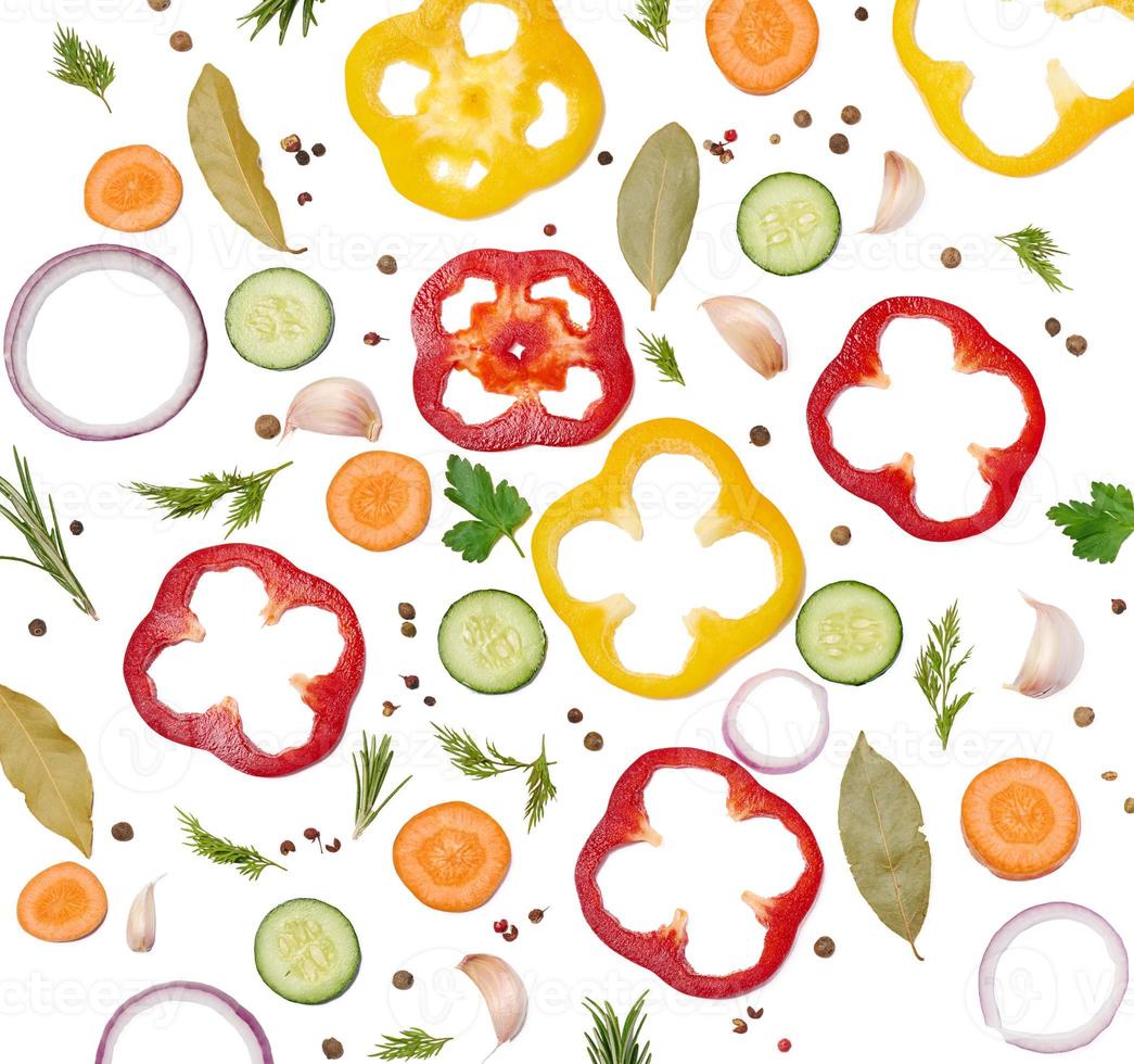 Fresh vegetables, onion, carrot, yellow and red bell peppers, a bunch of rosemary on a white isolated background. photo