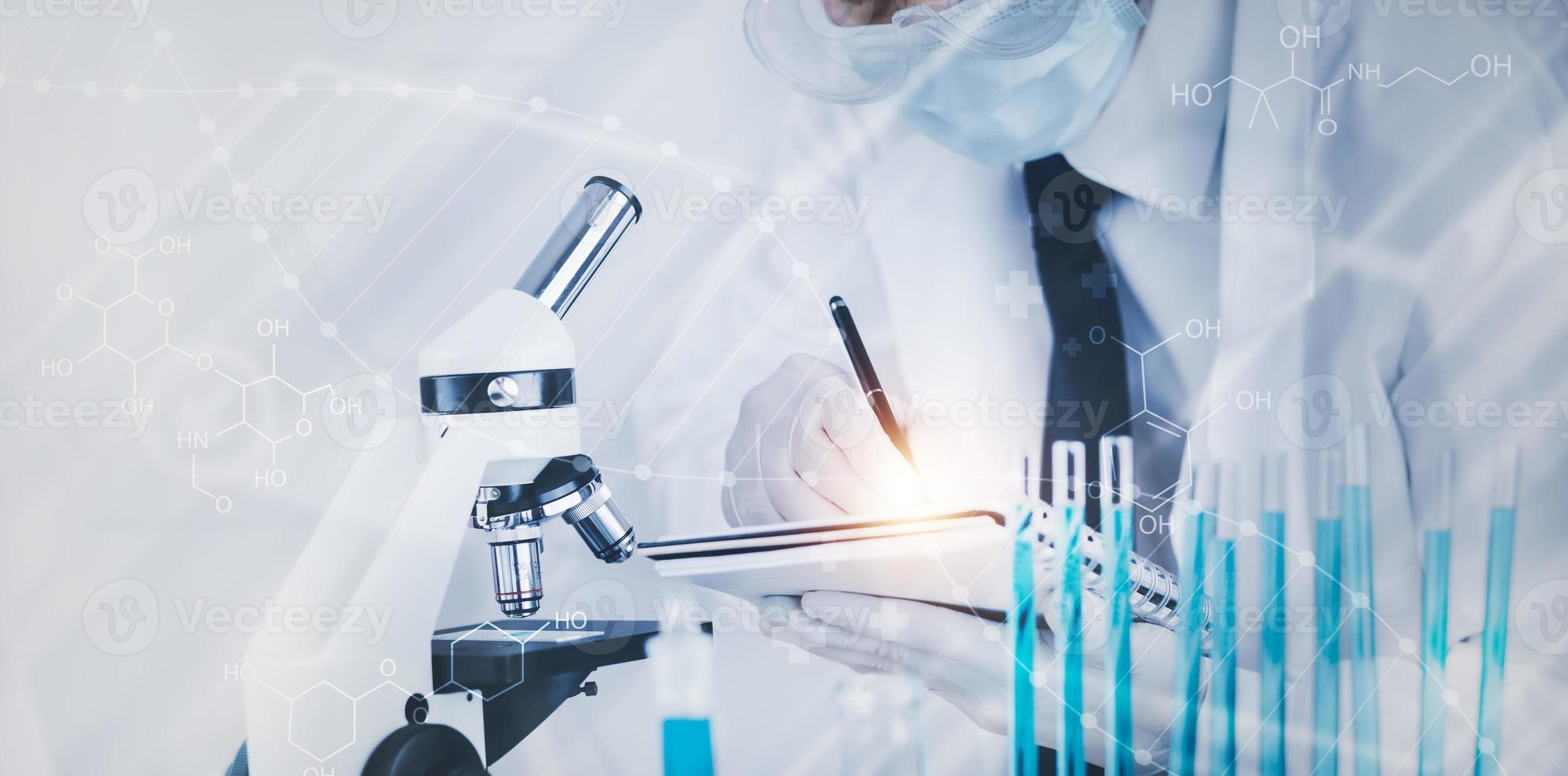 biochemical research scientist working with a microscope for the virus,Doctor man write a history of the experimental results in a , laboratory glassware containing chemical liquid for design. photo