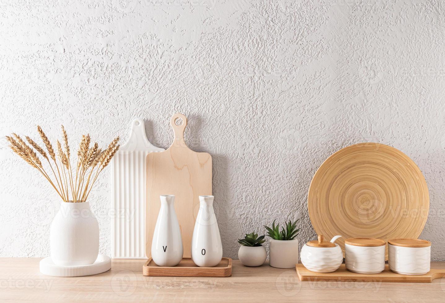 modern kitchen space in light colors. a set of various kitchen utensils on a wooden countertop. front view. ECO items. photo