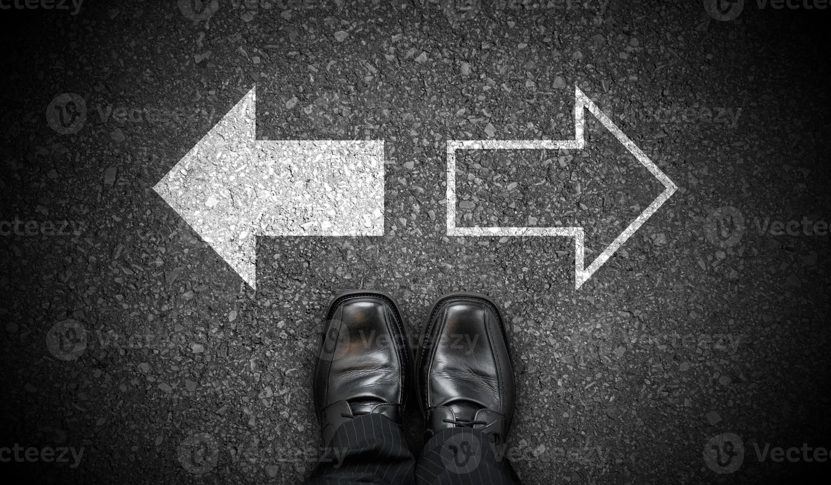 Black Business Shoes and Two Right and Left Chalky Arrows on Asphalt - Choice Concept photo