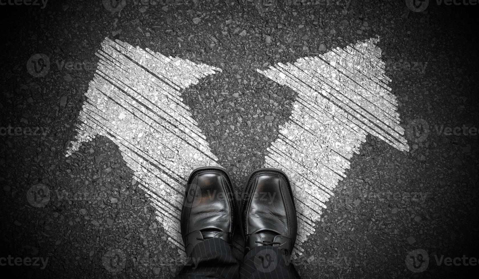 Black Business Shoes and Two Right and Left Chalky Arrows on Asphalt - Choice Concept photo