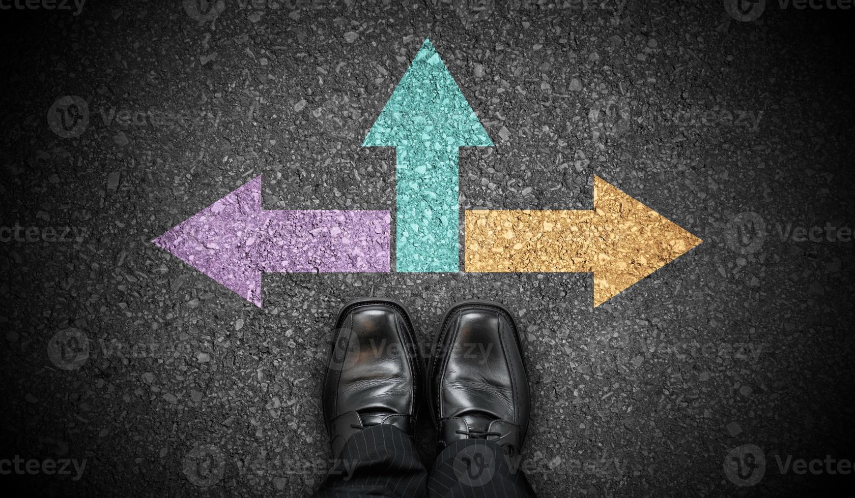 Black Business Shoes and Three Colorful Chalky Arrows on Asphalt - Strategy Concept photo