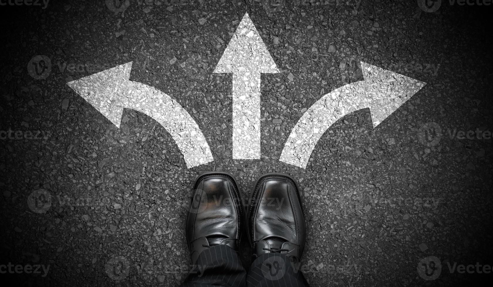 Black Business Shoes and Three Chalky Arrows on Asphalt - Decision Concept photo