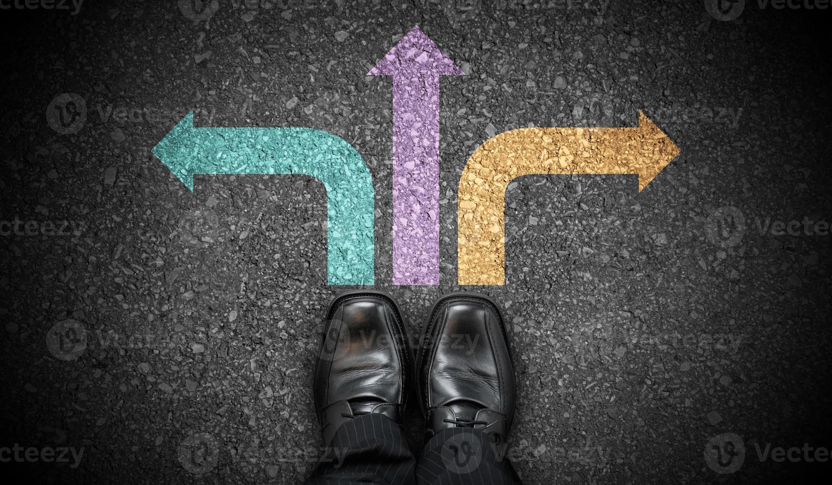 Black Business Shoes and Three Colorful Chalky Arrows on Asphalt - Strategy Concept photo